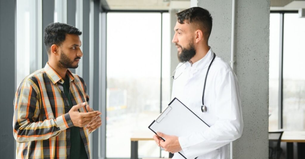 Man talks to his doctor.