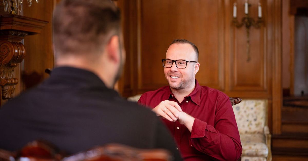 Dr. Mike talking with a client in his office.