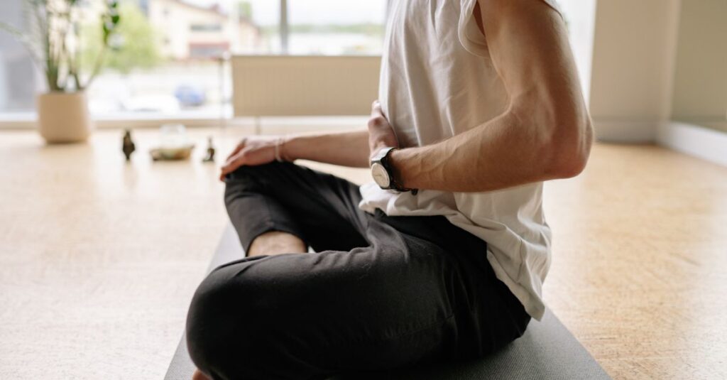 Man practicing self-care through mediation.