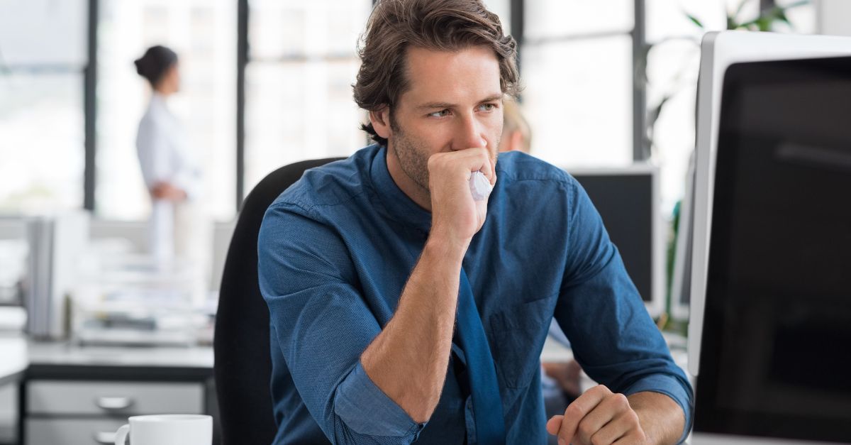 Stressed man looks frustrated sitting at his computer.