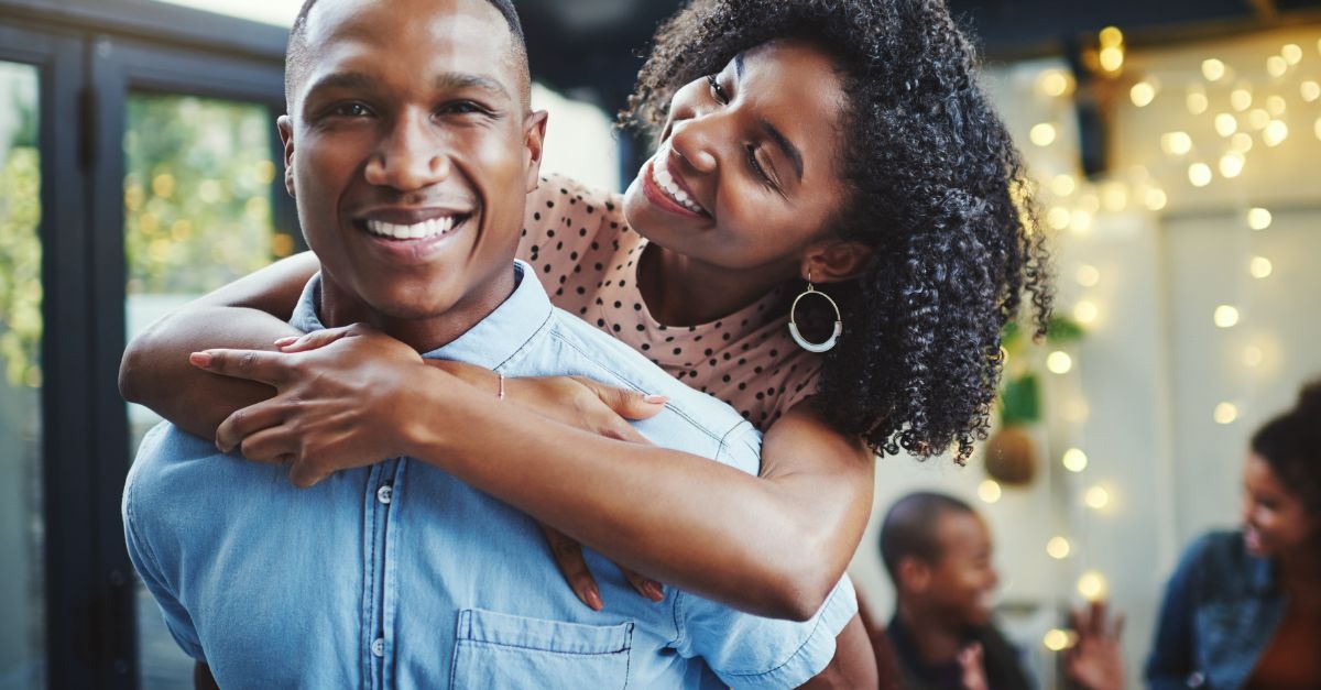 Happy couple sharing laughter and playfulness on date night, showing connection and joy.