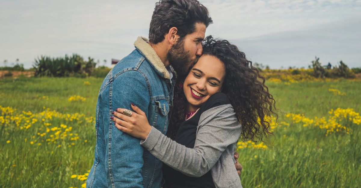 A loving couple walks arm-in-arm down a peaceful wooded path, symbolizing emotional intimacy, trust, and mutual connection in a supportive relationship.