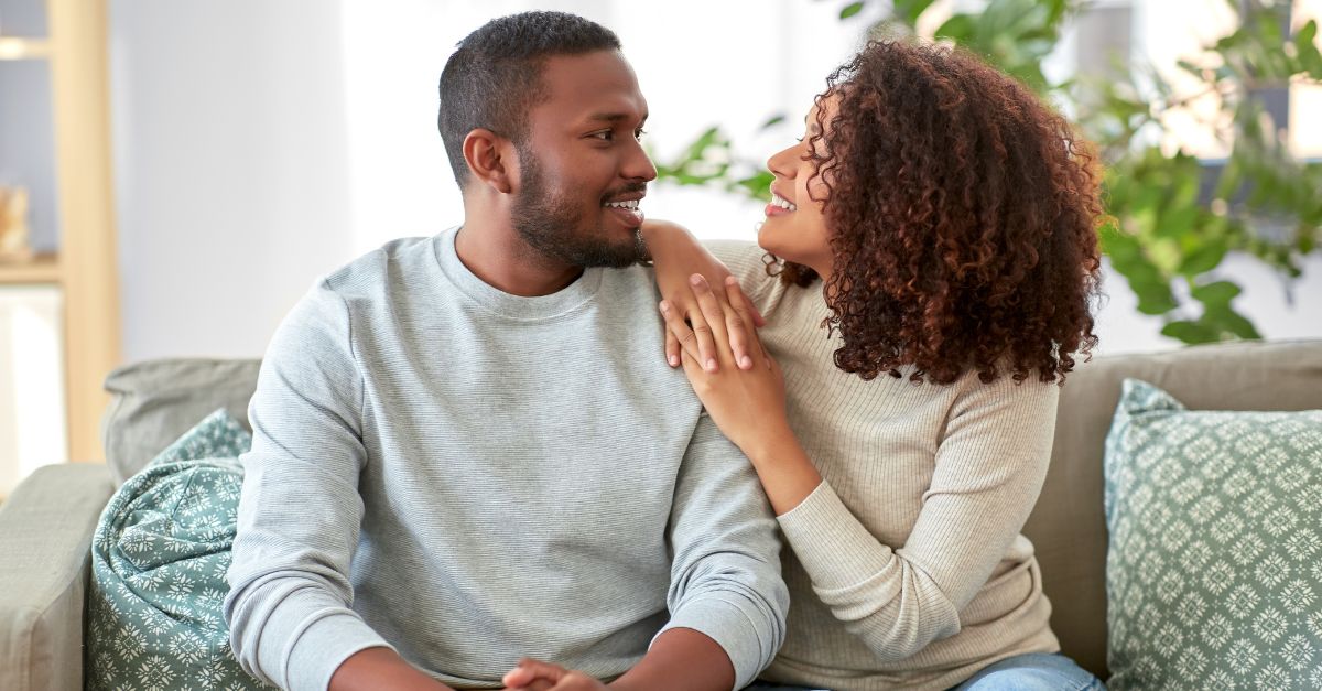 A man and woman talk together in a relaxed setting.