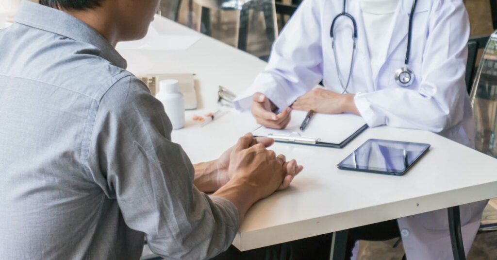 Transgender man having a supportive discussion with a healthcare provider, representing inclusive sexual health care.