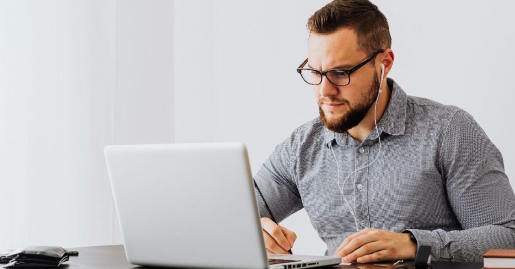Man at desk showing exhaustion and mental overload