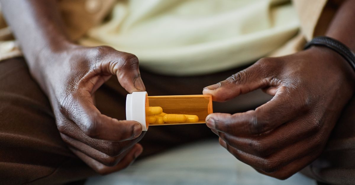 Man holding his prescription bottle.