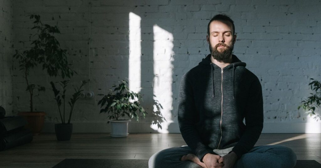 Man meditating with a serene expression.