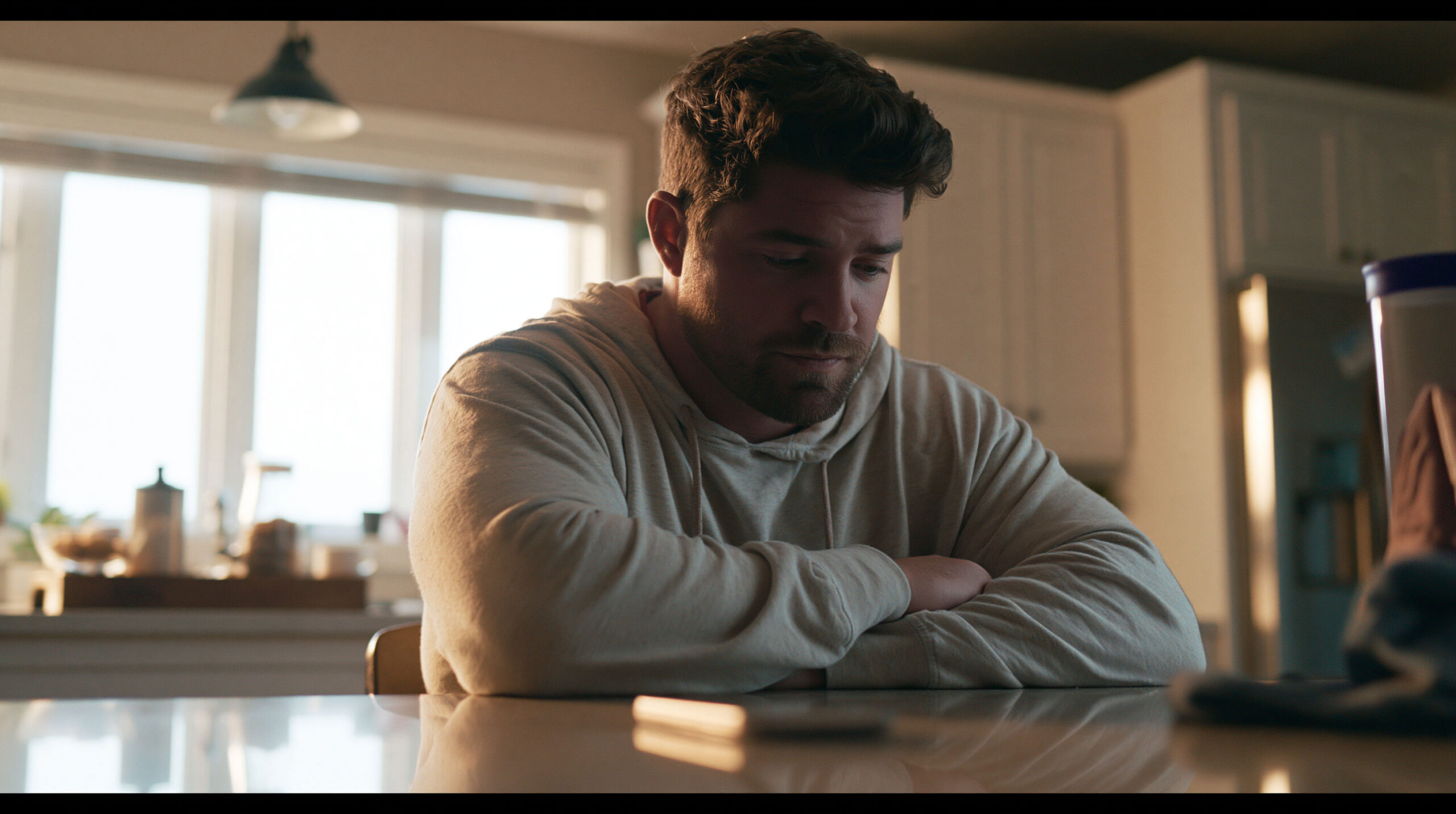 Man looking defeated, waiting for a phone call
